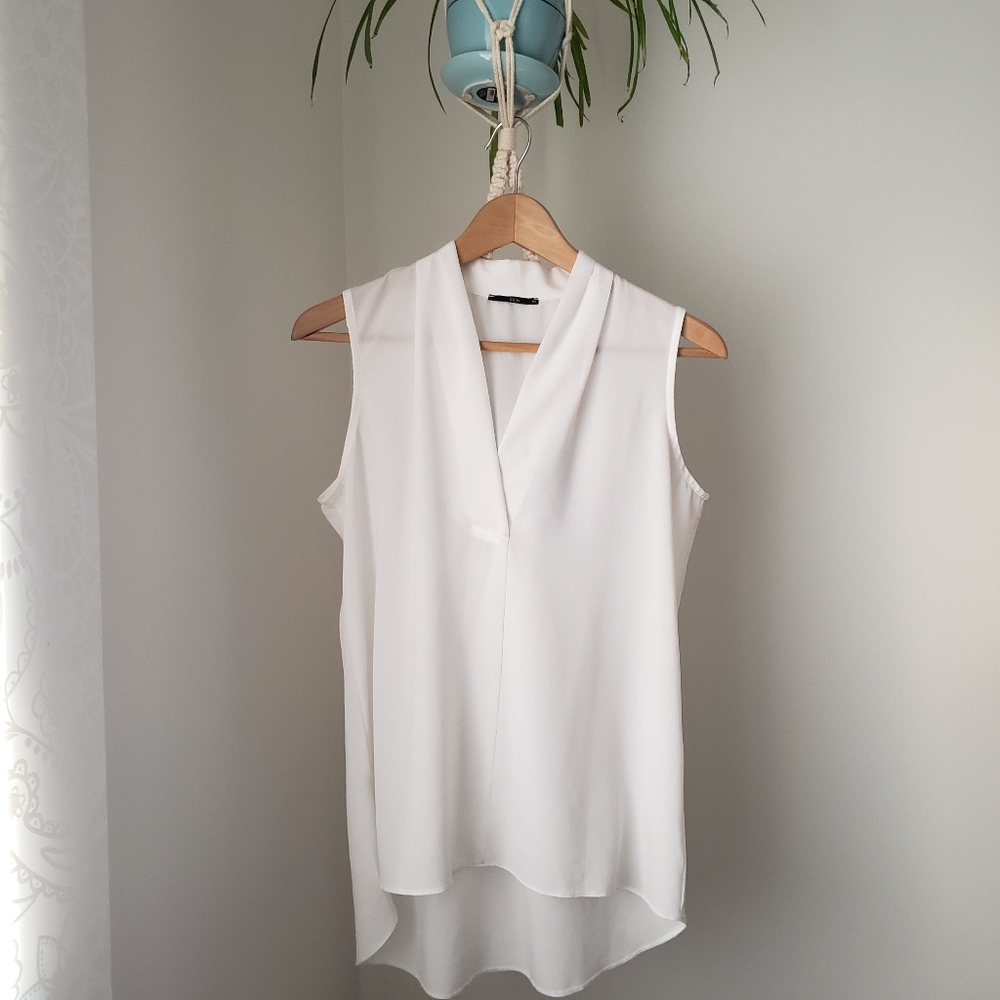 Free with purchase. Sleeveless sheer blouse in white size M like an S.